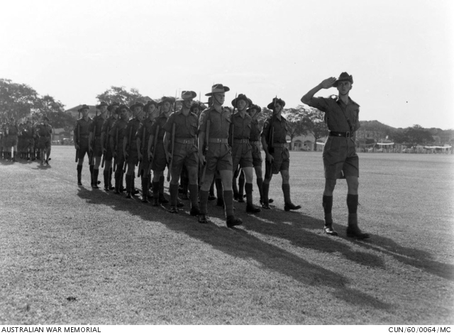 Members of 1st Battalion, The Royal Australian Regiment (1RAR) taking part in the ceremonial parade to mark the successful and official conclusion to the end of the Malayan Emergency in 1960. Leading the group are 1/4384 Corporal Les O Peters, of Balmoral, Qld, 3/6543 Private A H 'Bluey' Fotheringham, of Chernside, Qld, and Pte Churchais, of Fairfield, NSW. Members of 1RAR, the Malayan police and other Commonwealth troops also participated in the parade and march past the Premier of the state of Perak. 1960