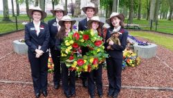 students hold wreath