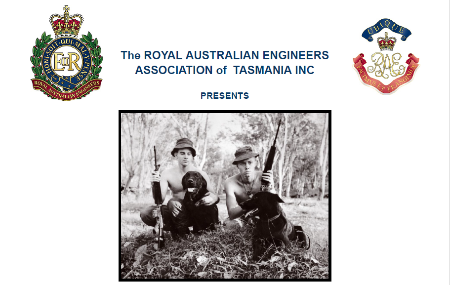 Two Australian soldiers with two black labradors